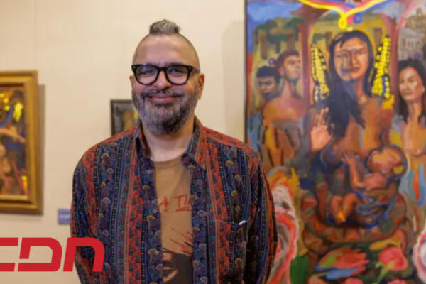 El artista dominicano Chiqui Mendoza, posando junto a una de sus obras. Foto: CDN Digital