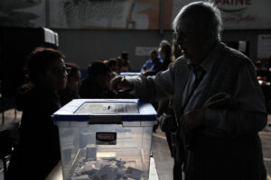 A woman casts her vote during the referendum for Chile's new constitution proposal, in Santiago, on December 17, 2023. - Chileans vote in a second referendum aimed at replacing the country's dictatorship-era constitution, with analysts saying the new proposal is even more conservative than the existing charter. The latest draft was overseen by the far-right Republican Party after voters roundly rejected a progressive version in September last year that attempted to enshrine environmental protections and the right to elective abortion. (Photo by Javier TORRES / AFP)